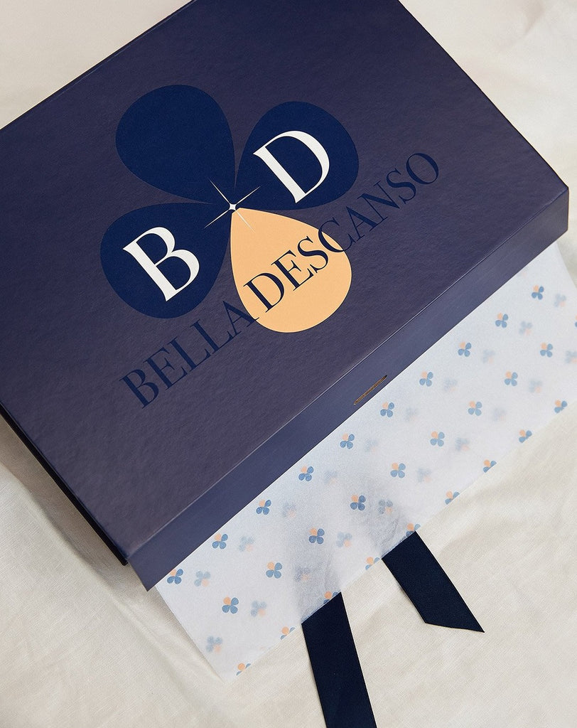 Bella Descanso branded gift box with ribbon tie and logo tissue paper. Luxe branding and packaging to make your Bella Descanso experience one not to forget and full of luxury and beauty. 